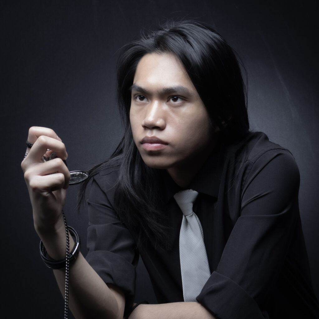 Image of male holding object looking off to the left