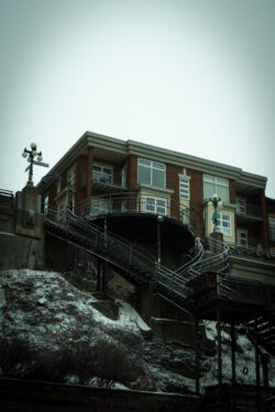 staircase leading to open balcony with structure behind